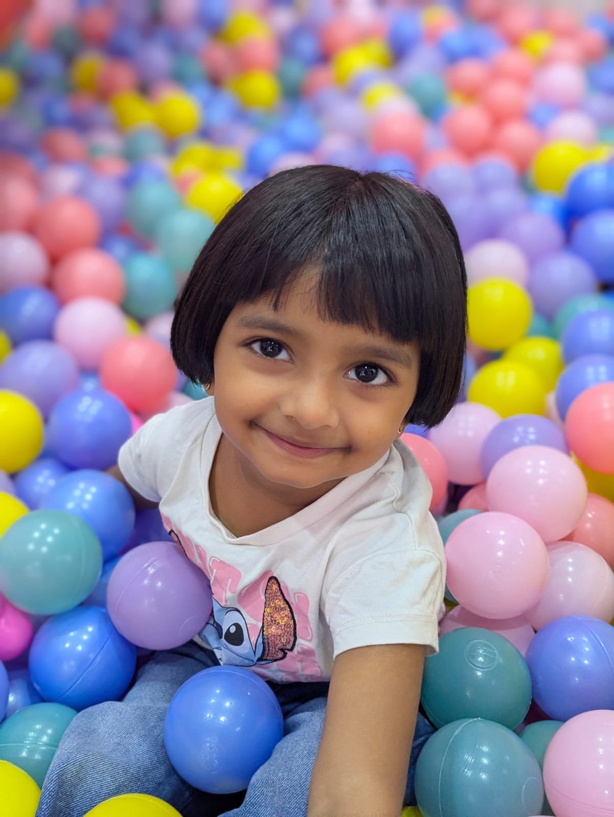 Toddler in the play area at Lollipop Locs before a first haircut visit